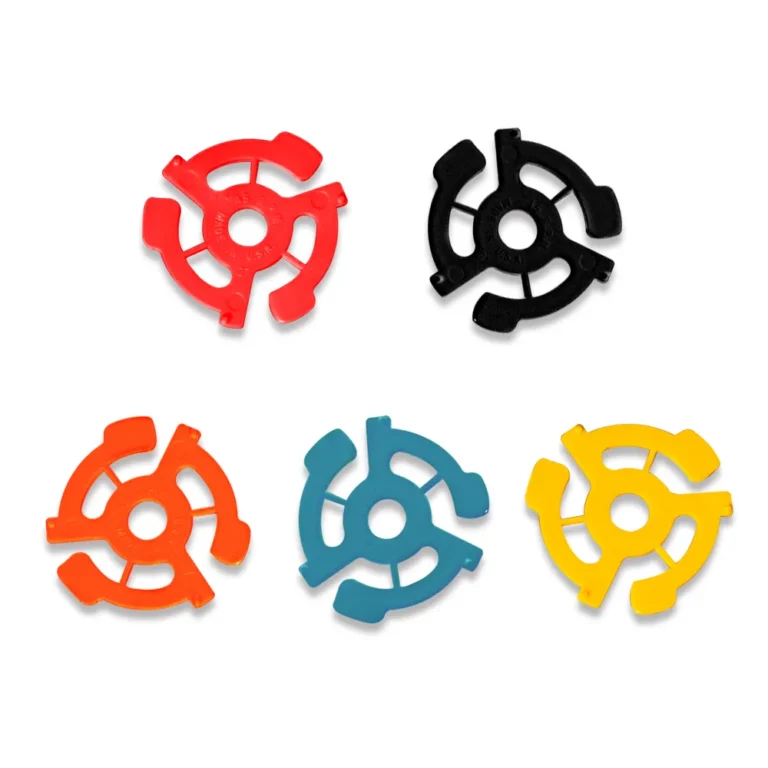 Five‑color plastic 45 rpm turntable adapters: red, black, orange, blue, yellow arranged flat lay